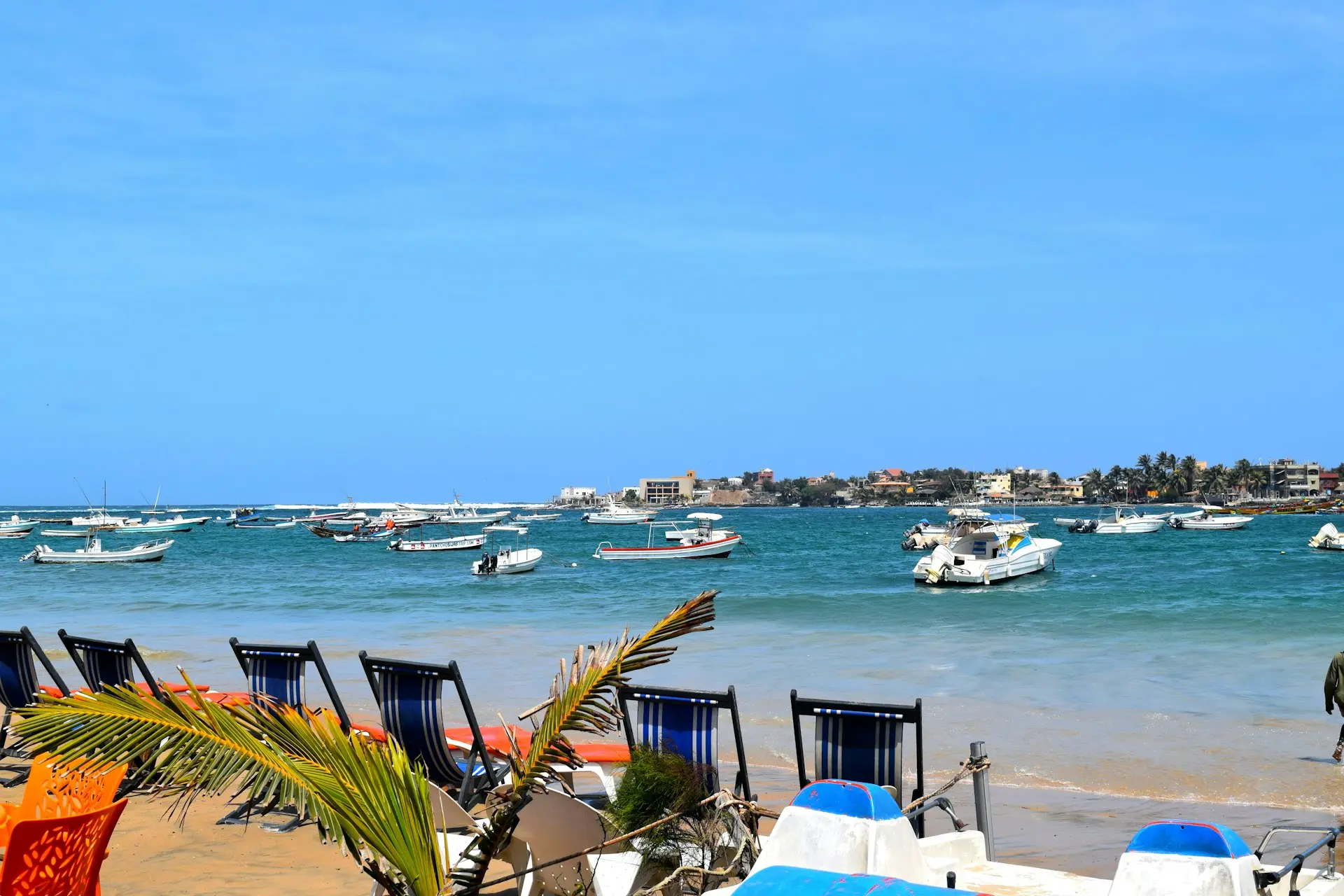 A bunch of chairs that are sitting in the sand
